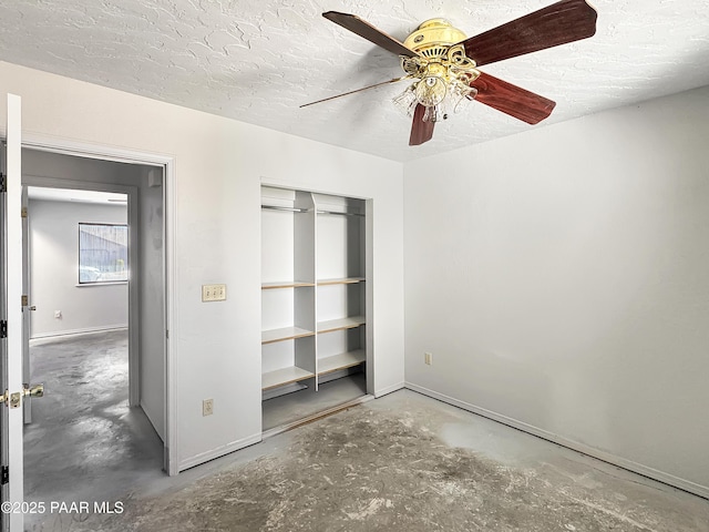 unfurnished bedroom featuring a ceiling fan, a textured ceiling, a closet, baseboards, and concrete flooring