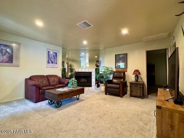 3169 Dome Rock Pl Unit 12A, Prescott, AZ 86301 - living room with light colored carpet, a tiled fireplace, and recessed lighting