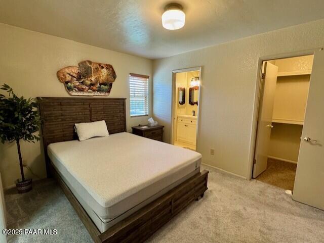 3169 Dome Rock Pl Unit 12A, Prescott, AZ 86301 - bedroom with light carpet and ensuite bathroom