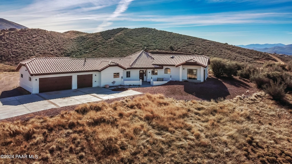 mediterranean / spanish home featuring a mountain view and a garage