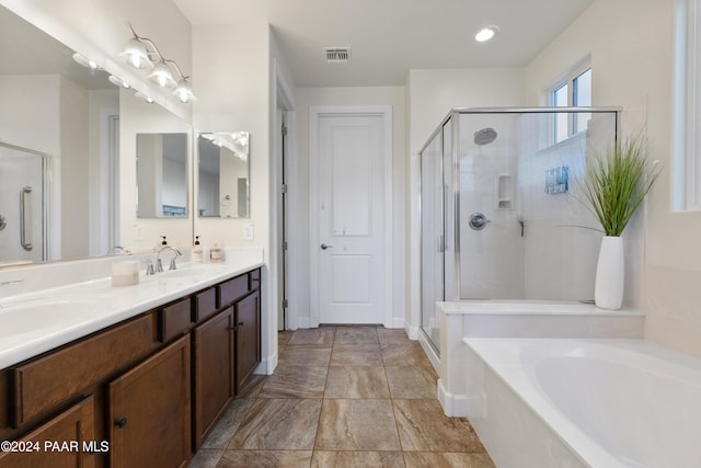 bathroom featuring vanity and separate shower and tub