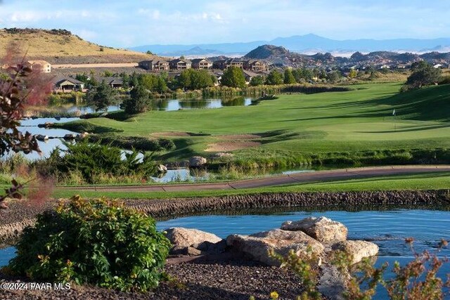 surrounding community featuring a water and mountain view