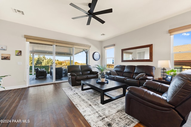 living room featuring dark hardwood / wood-style floors and ceiling fan