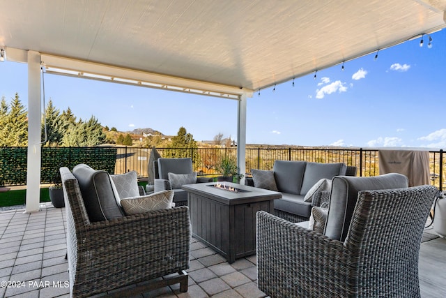 view of patio / terrace featuring an outdoor living space with a fire pit