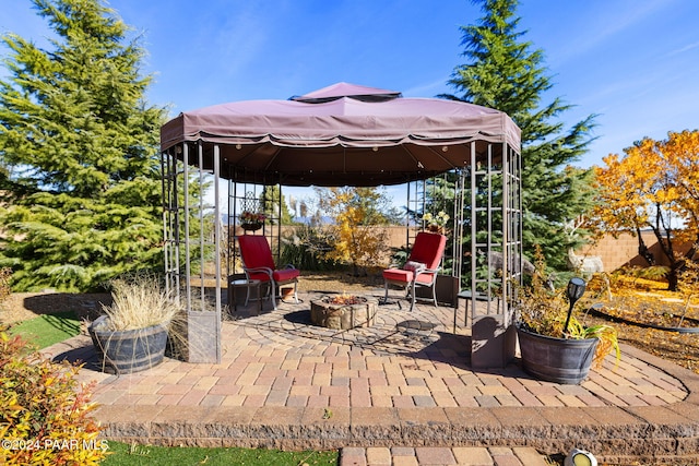 view of patio with a gazebo and a fire pit