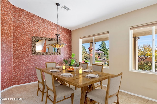 tiled dining room featuring plenty of natural light