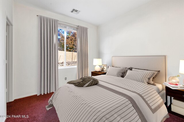 bedroom with dark colored carpet