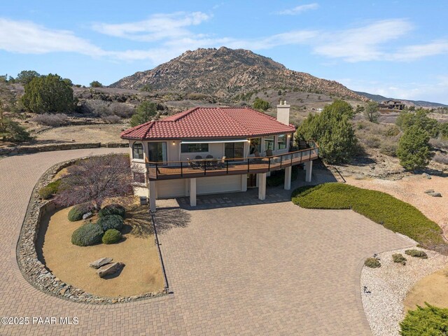2751 Boone Ct, Prescott, AZ 86305 - view of front facade with a tiled roof, a chimney, decorative driveway, an attached garage, and stucco siding
