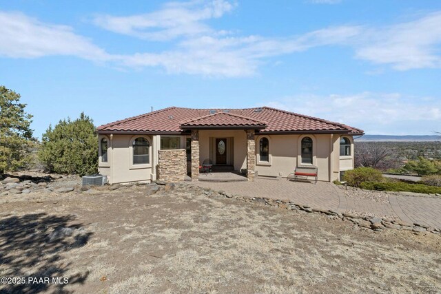 2751 Boone Ct, Prescott, AZ 86305 - mediterranean / spanish home featuring stucco siding, a tile roof, stone siding, and central AC unit