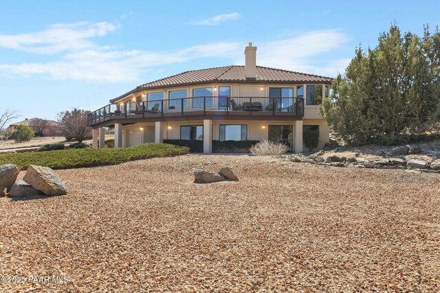 2751 Boone Ct, Prescott, AZ 86305 - back of property with a chimney, stucco siding, a tiled roof, and a wooden deck