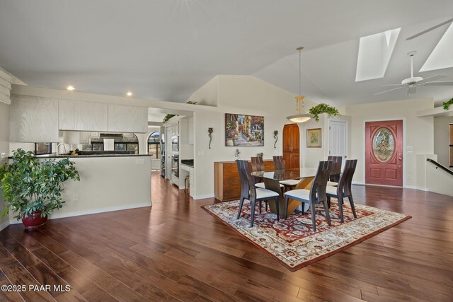 2751 Boone Ct, Prescott, AZ 86305 - dining room with lofted ceiling, dark wood finished floors, a ceiling fan, a skylight, and recessed lighting
