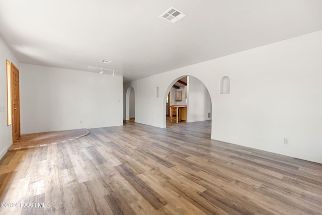 unfurnished living room with wood-type flooring