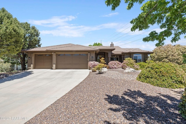 492 Locust Ct, Prescott, AZ 86301 - view of front of property with a garage, driveway, stucco siding, a chimney, and a tiled roof