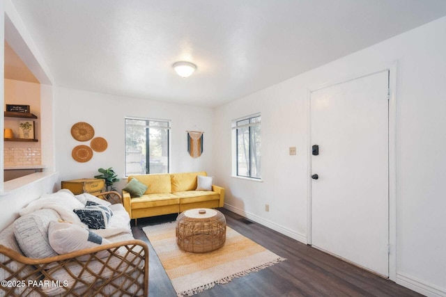 living room with baseboards and wood finished floors