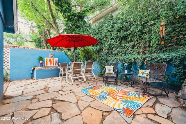 view of patio featuring fence