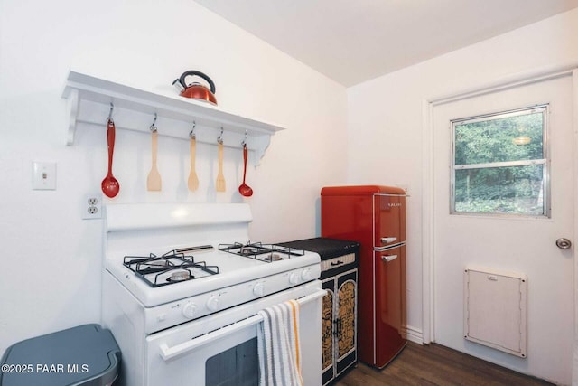 kitchen with white gas stove and dark wood-style flooring