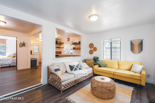 living room with wood finished floors, baseboards, and a wealth of natural light