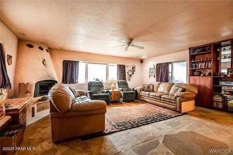 living room featuring a wealth of natural light and ceiling fan