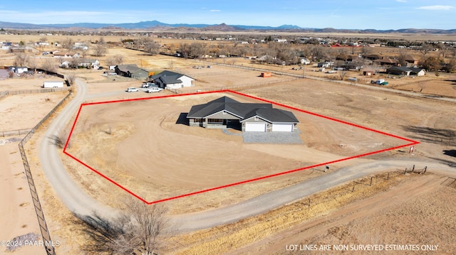 drone / aerial view with a rural view, view of desert, and a mountain view