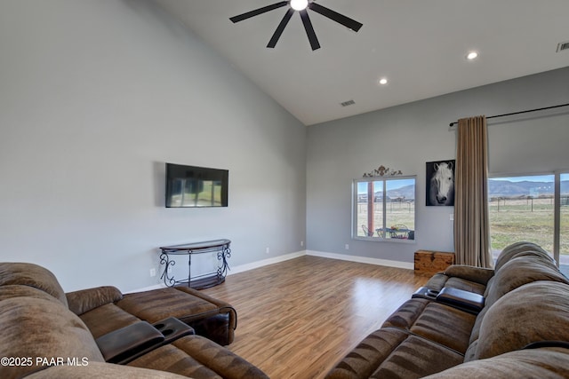living room with high vaulted ceiling, ceiling fan, wood finished floors, recessed lighting, and baseboards