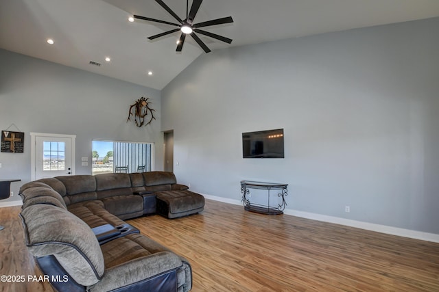 living room featuring ceiling fan, wood finished floors, baseboards, high vaulted ceiling, and recessed lighting