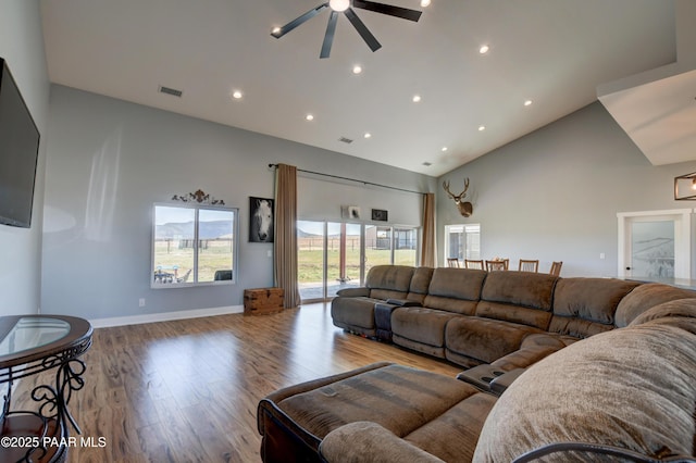 living room featuring ceiling fan, high vaulted ceiling, wood finished floors, recessed lighting, and baseboards