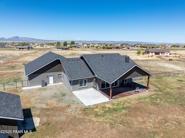 aerial view of property and surrounding area with a mountain backdrop