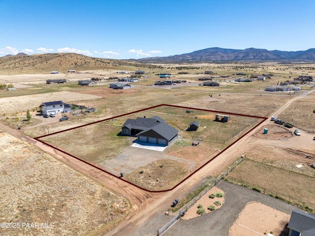 aerial view of sparsely populated area with property boundaries highlighted, mountains, and a desert landscape