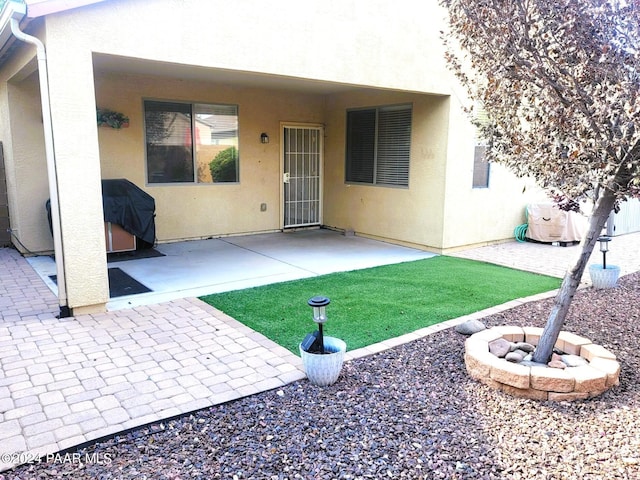 back of house featuring a fire pit and a patio area