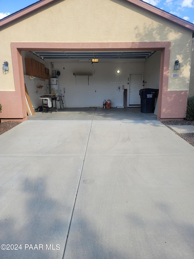 garage featuring a garage door opener and water heater