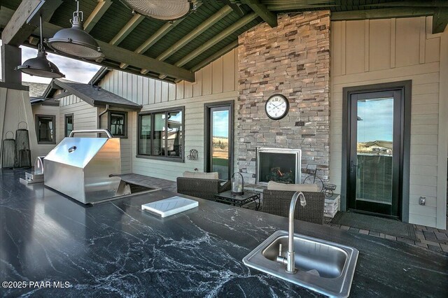 living area with an outdoor stone fireplace