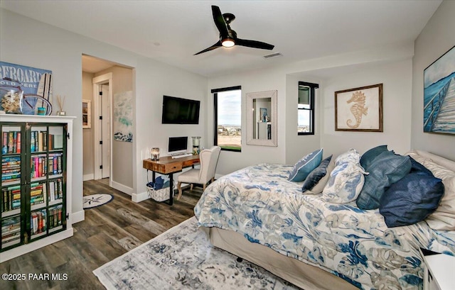 bedroom featuring visible vents, dark wood-style flooring, ceiling fan, and baseboards