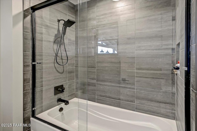 bathroom with shower / bath combination with glass door