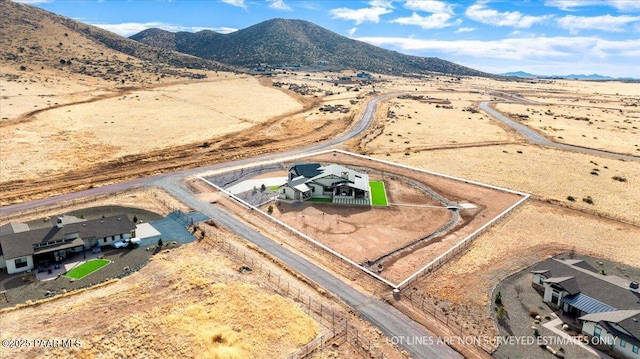drone / aerial view featuring a rural view, a mountain view, and a desert view