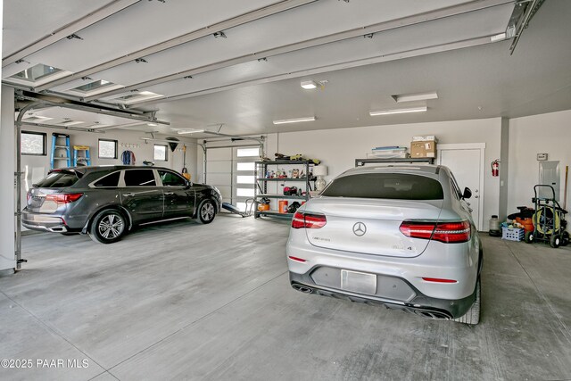 garage with freestanding refrigerator, refrigerator, and a sink