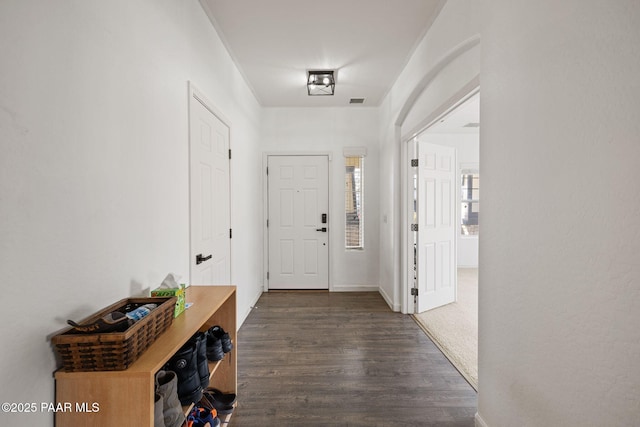 interior space with dark wood-style flooring and visible vents