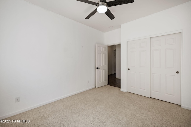 unfurnished bedroom featuring a ceiling fan, carpet floors, baseboards, and a closet