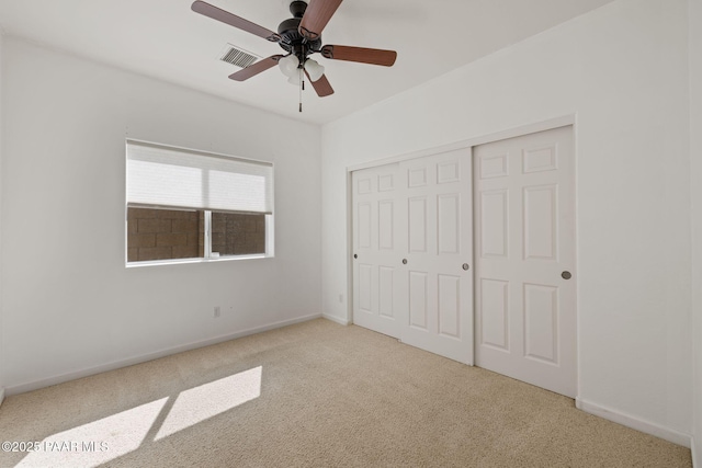 unfurnished bedroom with baseboards, visible vents, a closet, and carpet floors