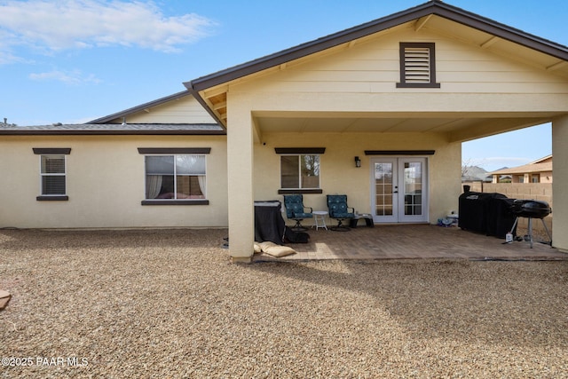 back of house featuring a patio, fence, french doors, and stucco siding