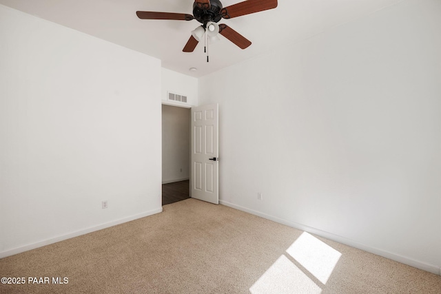 unfurnished room featuring baseboards, visible vents, carpet flooring, and a ceiling fan