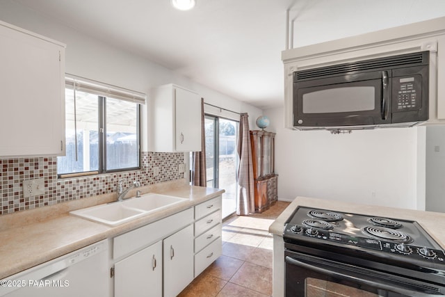 kitchen featuring backsplash, white cabinetry, black appliances, and a sink