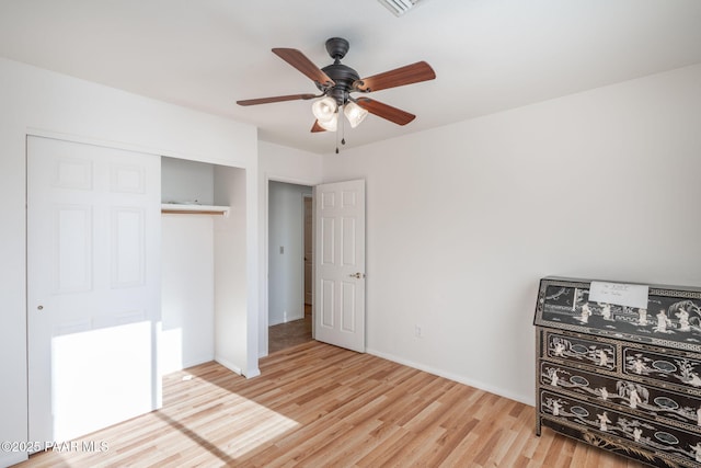 bedroom with a closet, baseboards, ceiling fan, and wood finished floors