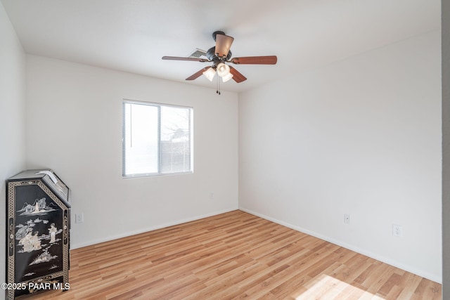 unfurnished living room with baseboards, a ceiling fan, and wood finished floors