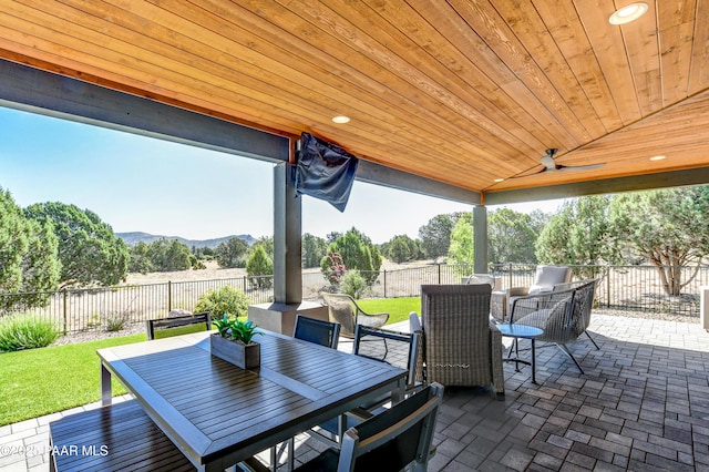 view of patio / terrace with a mountain view and ceiling fan