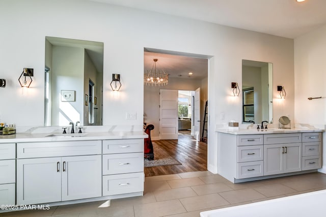 bathroom featuring tile patterned flooring, vanity, and a chandelier