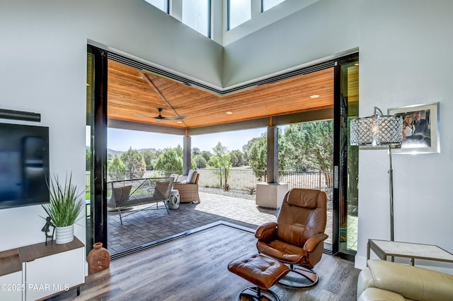 sunroom featuring ceiling fan