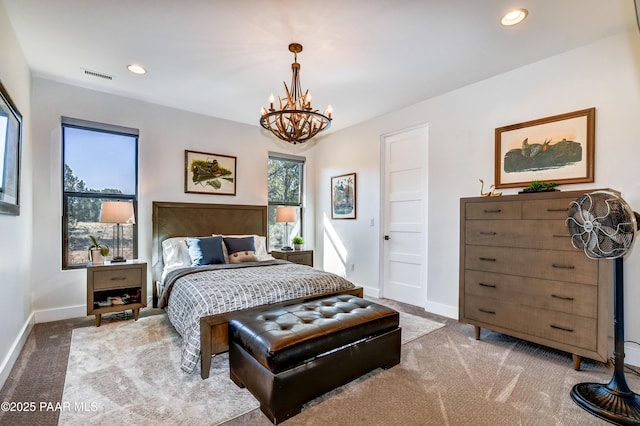 carpeted bedroom with a chandelier