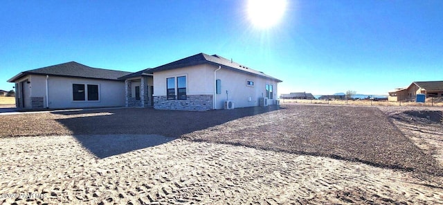 rear view of property with central AC unit