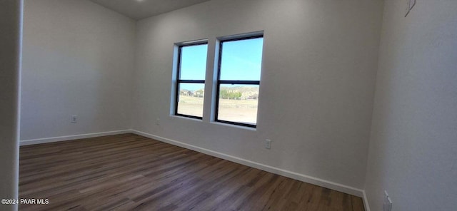 spare room with dark hardwood / wood-style floors