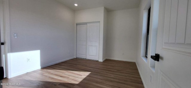 unfurnished bedroom featuring dark hardwood / wood-style floors